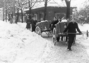 Removal of snow by young people with carts