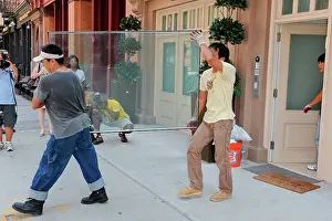 Pane: Repairmen remove damaged glass wall