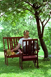 Ger002: Retired Relaxed Man Sitting in Backyard under