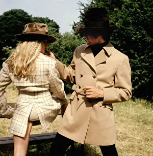 Sk-images: Retro couple modelling raincoats