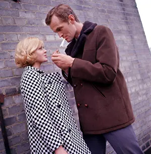 Alleys: Retro couple smoking by a wall