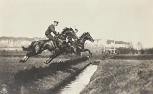 Steeplechases: Riders in uniform jump over a moat