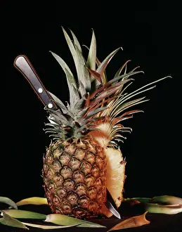 Pineapples: Whole Ripe Pineapple Cut in Half with Knife