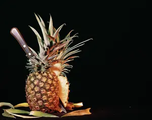 Pineapples: Whole Ripe Pineapple Cut in Half with Knife