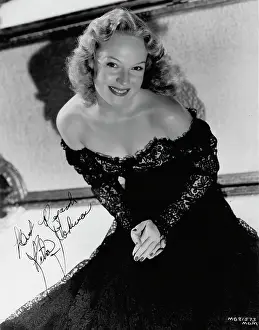 Fleecing: Rita Johnson wearing an evening gown designed by Dolly Tree