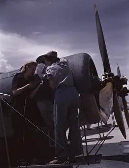 Propeller: A riveter and her supervisor working on an aircraft, 1942