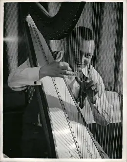 Specialises: Robert Maxell playing the harp, London