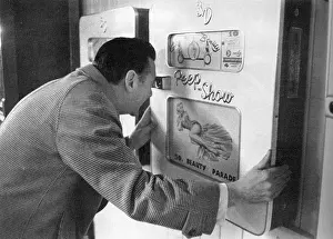 Voyeur: Robin Maugham looking at a peep-show in Brighton