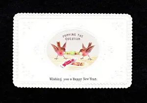 Popping: Two robins pulling crackers on a New Year card