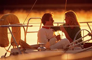 Consume: Romantic Couple Drinking Wine Sitting on Deck