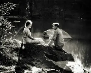 Romantic Couple Sitting on Boulder