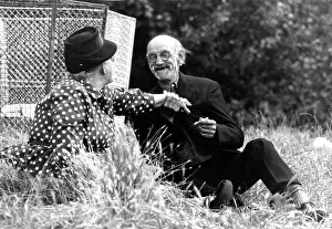 Clasps: Romantic old couple by waste bin, Hampstead Heath