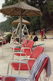 Sunshades: A row of red beach chairs, Corfu