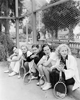 Rackets: Row of tennis players with rackets