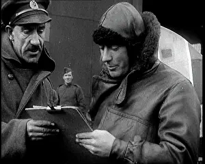 Clipboard: Royal Air Force Pilot Reading A Clipboard In Flying Gear