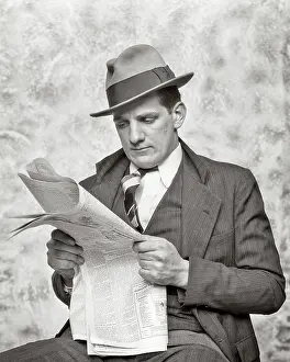 Rumpled: Rumpled Businessman with grim expression reading paper