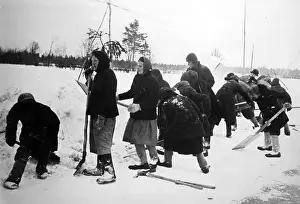 Shovels: Russian forced laborers clear a runway, 1942
