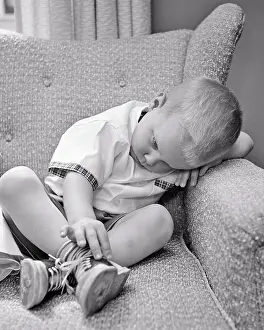 Disciplined: Sad Boy Having Time Out Sitting in Easy Chair