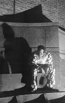 Finale: Sad harlequin under a bridge in Munich, 1929