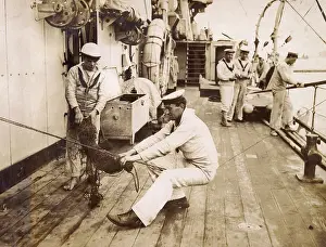 Tight: Sailor binding a swab, sitting on a rope, WW1