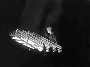 Batteries: Sailor Checks on the Spotlight of a Battery, 1940