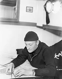 Measurer: Sailor looking over a map with a compass