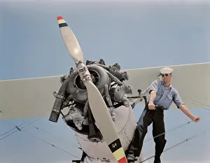 Starting: Sailor starts the engine of a N3N taining biplane, 1942