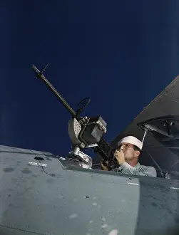 Bombardier: Sailor tries out a.30-caliber machine gun