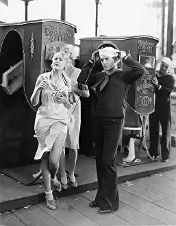 Boardwalks: Sailor and a woman standing together on a boardwalk