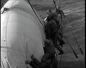 Washed: Sailors Hanging On To A Sail on a Large Sailing