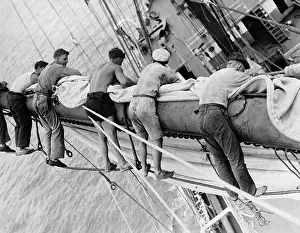 Masted: Sailors in the rigging of a schooner, 1930