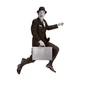Businesspeople: Salesman leaping in air holding briefcase and