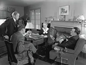 Salesperson: Two salesmen making sales presentation to older