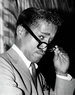 Peering: Sammy Davis Jr, American singer and dancer, at reception