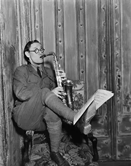 Instrumentalist: Saxophone player reading music on foot