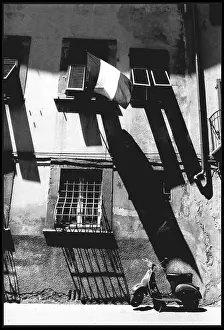 Scooter: Scooter and flag - shadows, Pisa, Italy