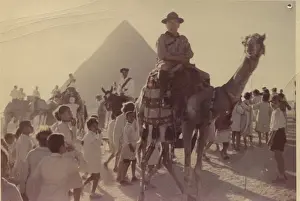 Akita: Scout leader on camel in front of pyramid, Egypt