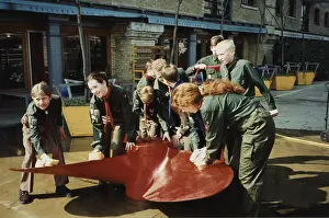 Scouts cleaning propeller near Tower Bridge, London