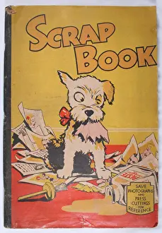 Illustrative: Scrap book with a dog chewing paper