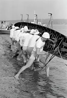 Coordinate: Sculling Team Lifting Boat Into