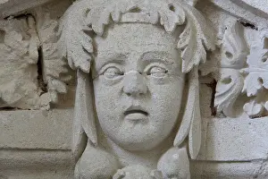 Gironde: Sculptural detail of a head on a pediment above