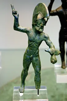 450bc: Sculpture of a warrior in attack attitude. Bronze. 475-450 B