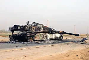 Abrams: A scuttled Abrams Tank rests in front of ?