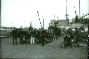 Assemble: Sea Scouts assembling on a quay