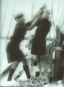 Hoist: Two Sea Scouts hosting a sail on a ship