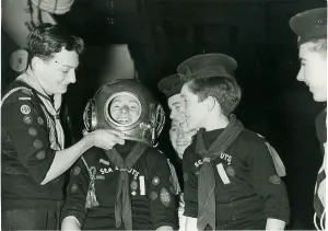 Divers: Sea Scouts trying out a diver's helmet