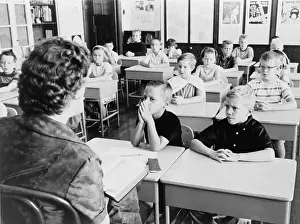 Readings: Second grade students listen as their teacher, ?