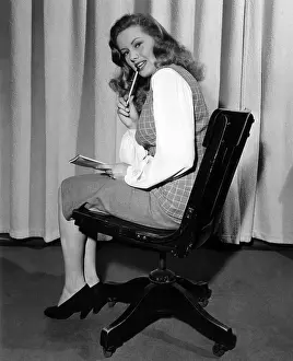 Businesswoman: Secretary biting pencil