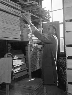 Joiner: Selecting timber at a cabinet makers, Shoreditch, London