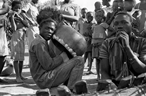 Mbira: Sena man playing mbira inside calabash resonator with